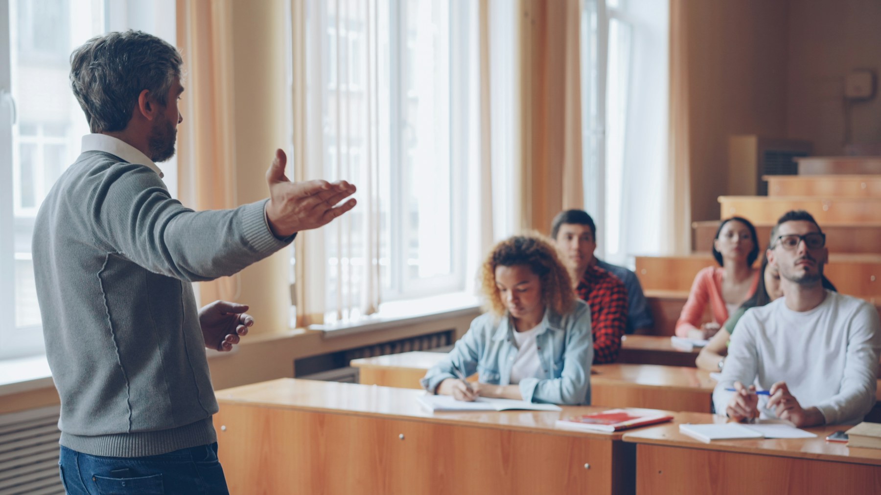 A university professor speaking to students in a lecture hall